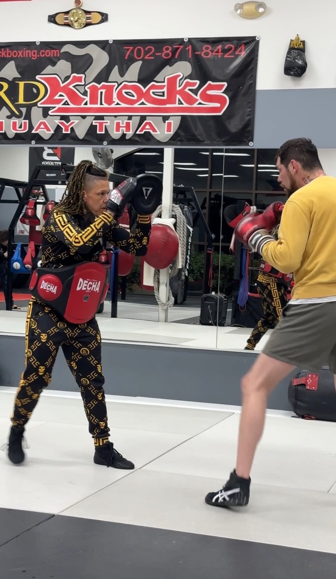 Cody coaching Muay Thai pad work during a private session